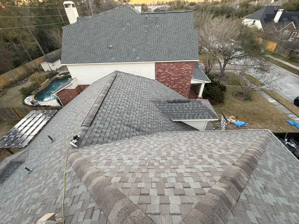 Completed architectural shingle roof by Bluebonnet at golden hour on a Houston home